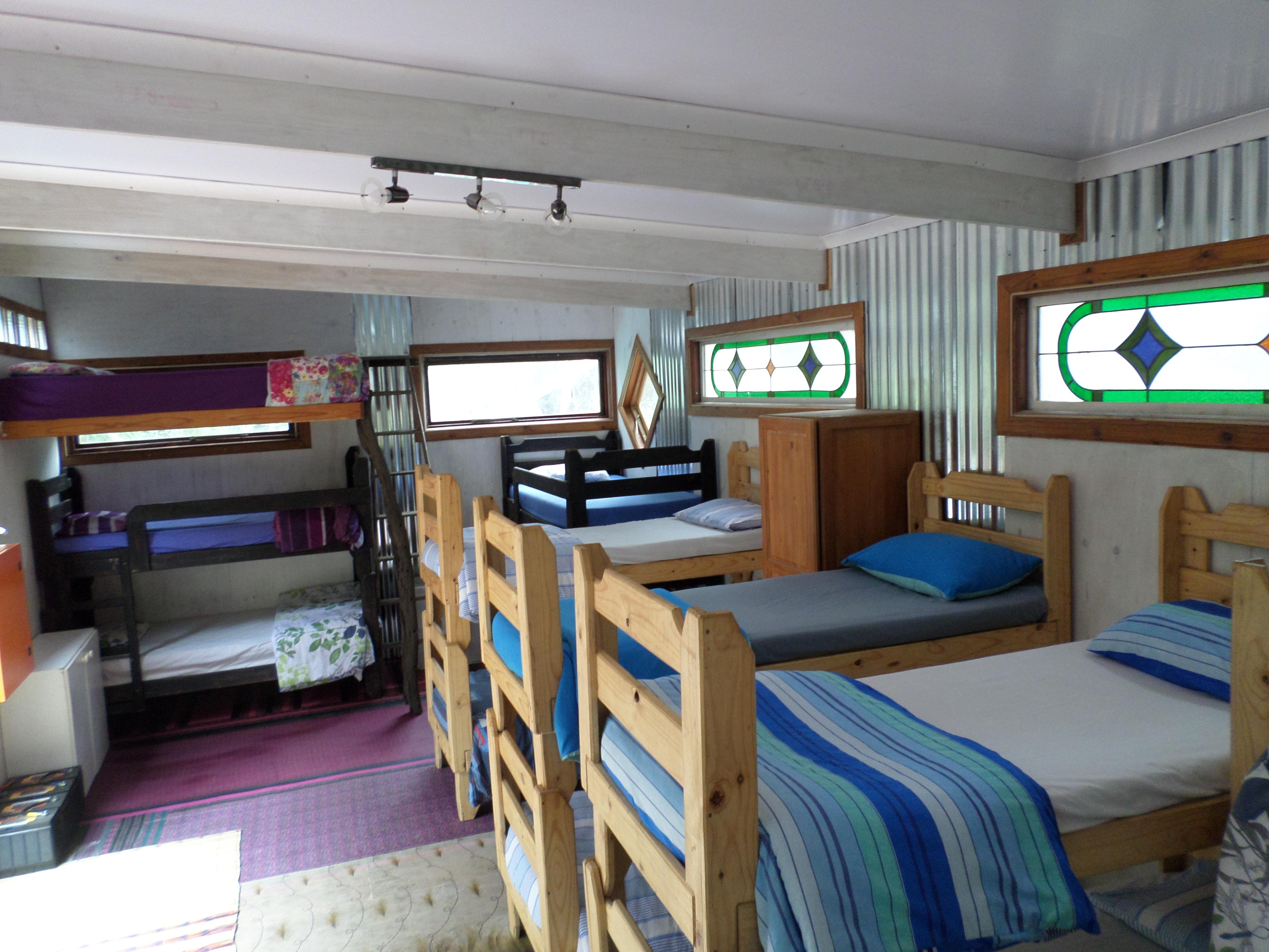 Dorm view of 10 of the 12 single bunks and 1 double 